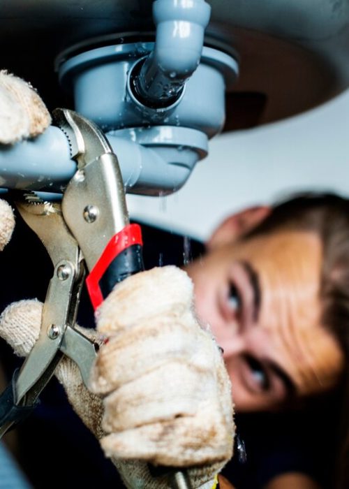 man-fixing-kitchen-sink_53876-13430