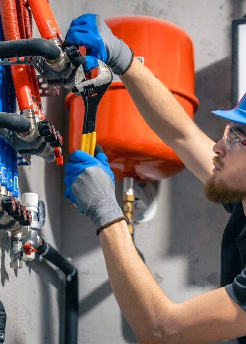 man-installs-heating-system-house-checks-pipes-with-wrench_169016-55834